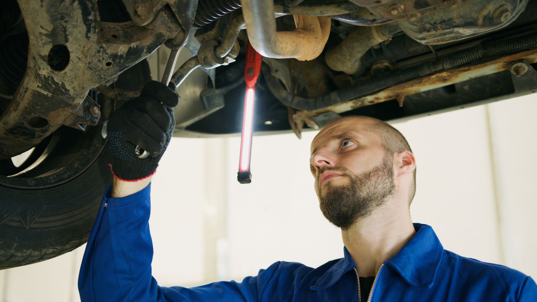 Mechanik podniesionego Renault podczas przeglądu w warsztacie